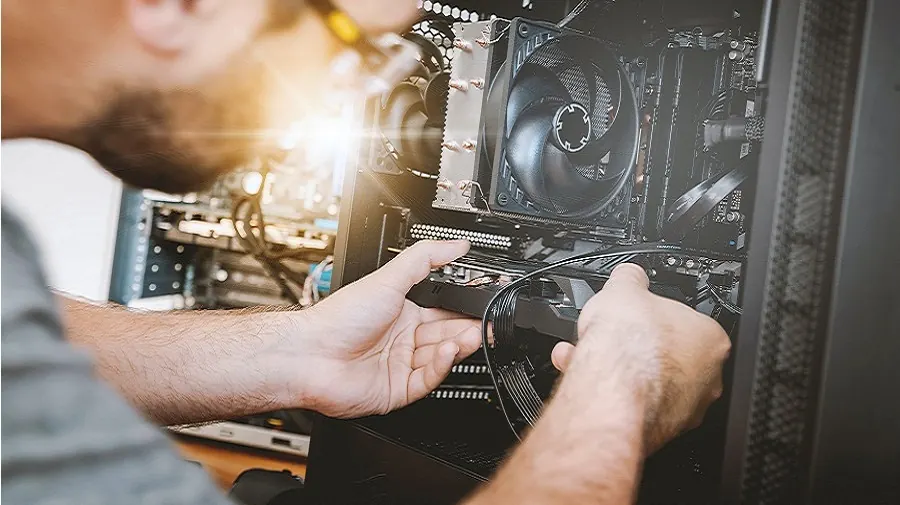 Technician repairing and upgrading a desktop computer in Christchurch